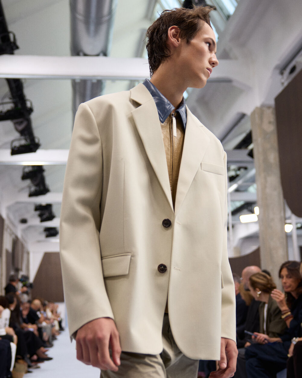 Model wearing a cream Marni tailored blazer layered over a leather shirt